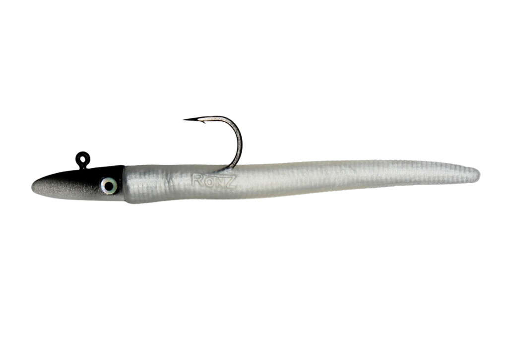 A soft plastic fishing lure shaped like a small eel or worm, with a black head, white eye, and a single metal hook attached at the front, shown on a plain white background.