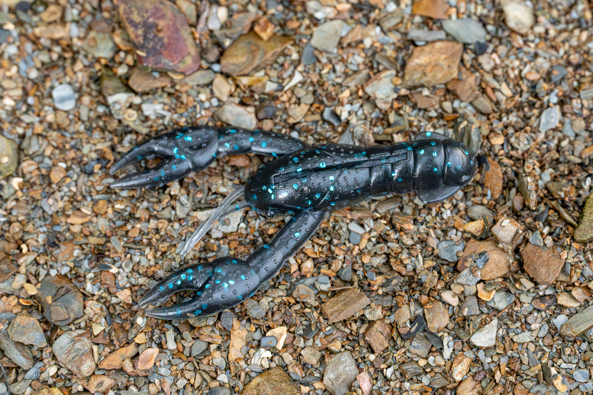 Craw lure on a bed of small stones and pebbles